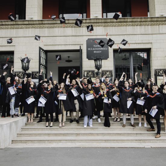 students throw their caps in the air to celebrate their graduation at the american hotel academy graduation ceremony 2022